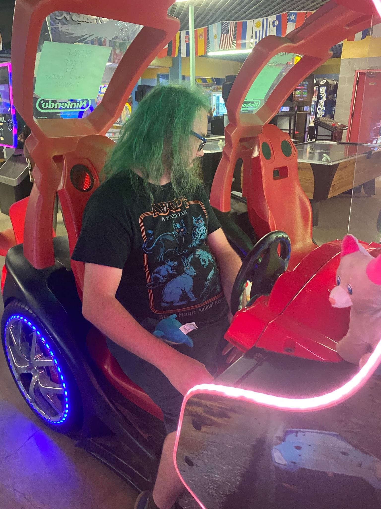 A man with green hair plays a modern driving game, Photo 1